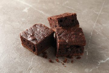 Chocolate cake slice on grey background, close up