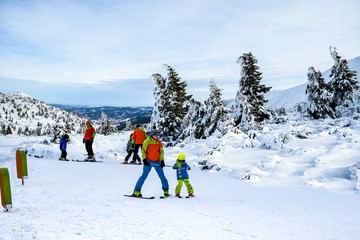 Fototapeta na wymiar Skiing on fresh snow at winter season at beautiful sunny day . Ski resort in the mountains in winter