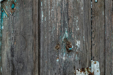 Old rotten wooden boards with peeling paint