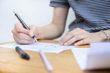 high school,university student study.hands holding pencil writing paper answer sheet.sitting...