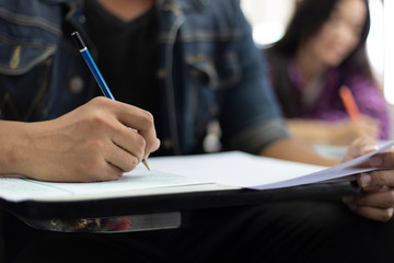 high school,university student study.hands holding pencil writing paper answer sheet.sitting...