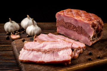 Smoked meatloaf on dark wooden background.