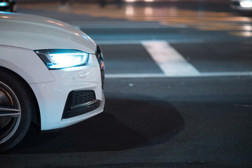 white car in road at night