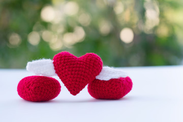 Obraz premium Beautiful red heart on a natural bokeh background. Valentine's Day .