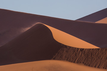 Sand floating over the Dunes at the endless namib desert