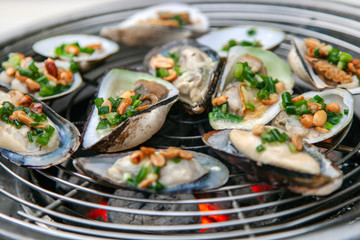 sea food, cooking seafood on a barbecue, shrimps, oysters, frog legs, squids, lobsters, close-up