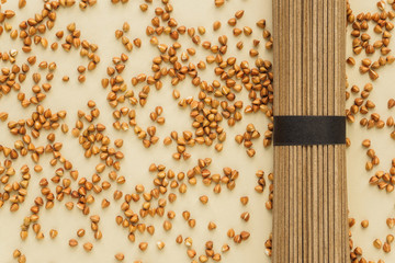 Buckwheat pasta and buckwheat on beige background with copy space