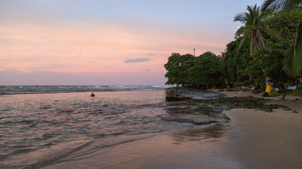 Sunset on the black sand beach of Puerto Viejo, Costa Rica
