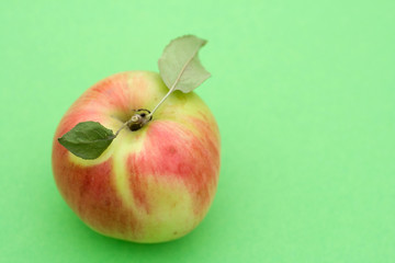 Juicy apple on green background