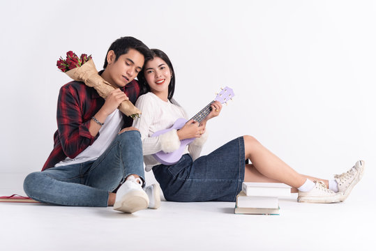 Beautiful Young couple at home,enjoy spend time together in celebration Saint Valentine's day,hand hold gift,selfie photo with hand phone,happy and love motion.