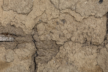 Old destroyed clay wall of a half-timbered house with cracks