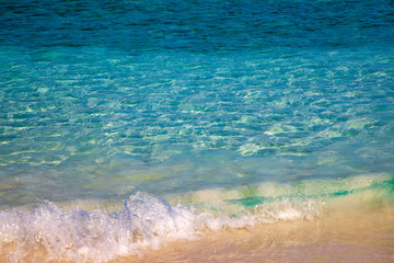 Sea wave and sand. On the beach, Soft wave of blue ocean on sandy beach. Background.