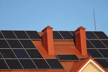 Roof of a house with solar panels, alternative energy sources