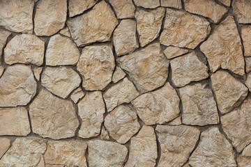 Wall of wild beautiful brown brown large stone