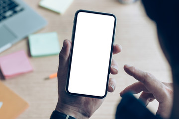 Mockup image blank white screen cell phone.man hand holding texting using mobile on desk at office.background empty space for advertise text.people contact marketing business,technology 