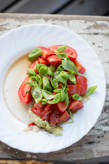 Tomato salad with lettuce, basil and vinaigrette