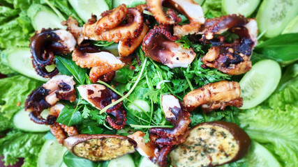 Delicious grilled octopus on metal grill seafood bbq with chili sauce spring onion tentacles calamari tasty marinated Vietnamese street food Asian cuisine