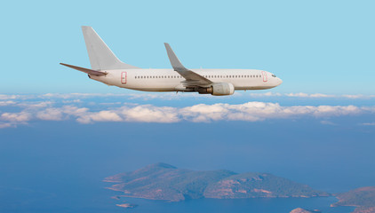 Airplane in front of the white clouds and mountains