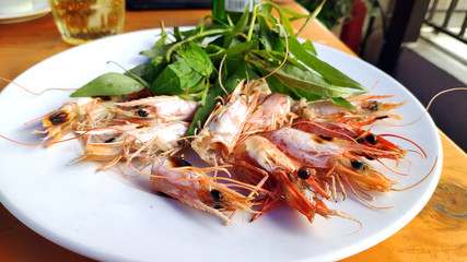 Big red shrimps Delicious king prawn boiled with head and  sweet chillies sauce green vegetable herbs on white plate Asian cuisine Thai traditional food healthy fresh seafood