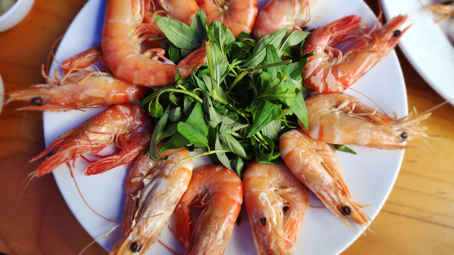 Big red shrimps Delicious king prawn boiled with head and  sweet chillies sauce green vegetable herbs on white plate Asian cuisine Thai traditional food healthy fresh seafood