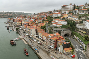 Fototapeta na wymiar Porto old town riverside aerial promenade in Portugal. Picturesque old houses among the Douro River