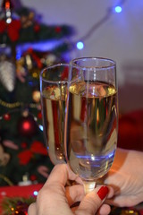 Champagne of glasses in the hands holiday background