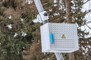 Security cameras hanging on the city park lantern.