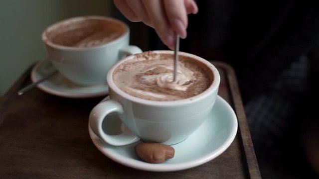 two cups of hot latte on a date