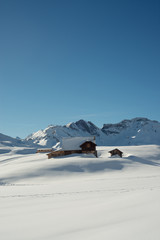 Old house in alpine winter landscape