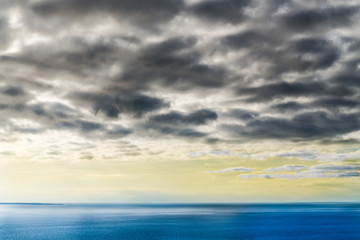 Naklejka na ściany i meble Beautiful serene overcast and tranquil sea and sky background. Neutral copy space for text