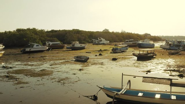 Aerial drone flight over boats at aground on the sunset, Bali, Indonesia, 4k