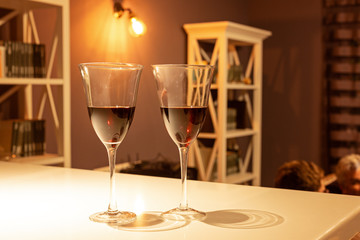 Two glasses of red wine in a cozy interior