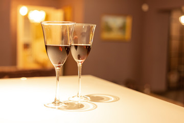 Two glasses of red wine in a cozy interior