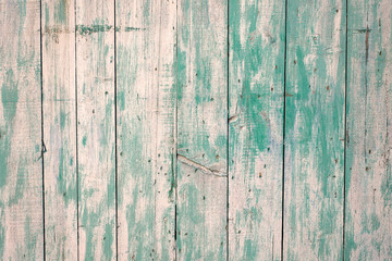 Texture of old wood rustic background with peeling blue paint. Old wooden door.