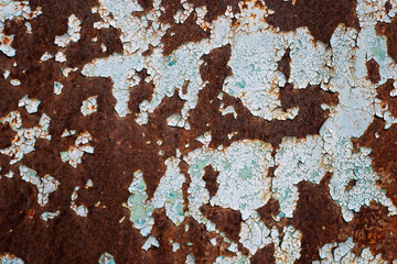 Multicolored background: rusty metal surface with blue paint flaking and cracking texture