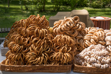 Rows of freshly made bagels with poppy seeds and sugar powder