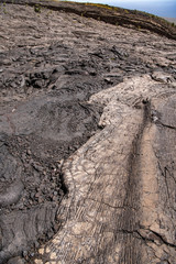close up showing the textured surfaces of two different volcanic lava flows overlapping on the Big Island, Hawaii