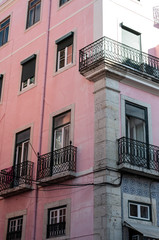 Fototapeta na wymiar Traditional Portuguese apartments, painted pink, taken on a sunny summer day in Lisbon.