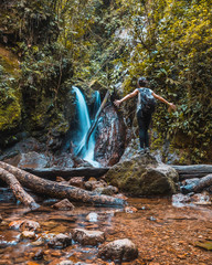 A young woman enjoying the natural waterfall of the Cerro Azul Meámbar National Park (Panacam) in Yojoa. Honduras