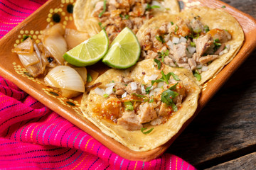 Mexican beef tacos also called "suadero" on wooden background