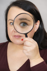 Adult woman with magnifying glass