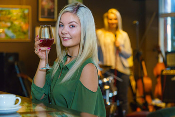 Girl with alcohol glass in pub club