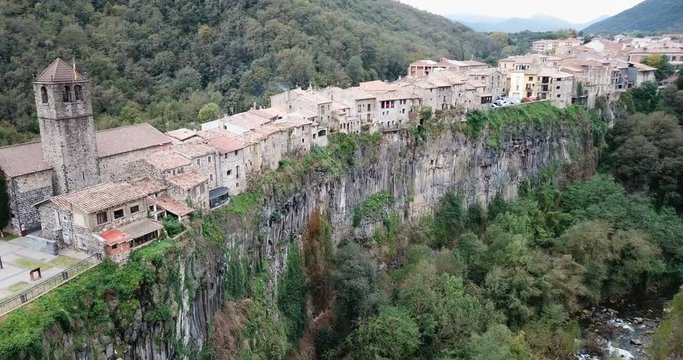 Aerial view of Castellfollit de la Roca, medieval Catalan hamlet on cliff on autumn day
