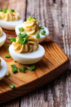 Deviled eggs on rustic wooden background