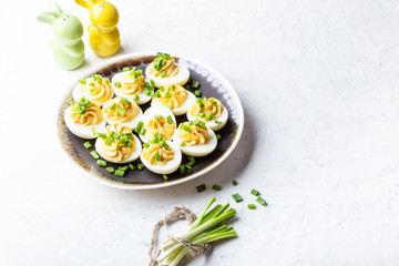 Deviled eggs in rustic ceramic plate