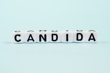 Candida inscription on cubes. Medical blue background