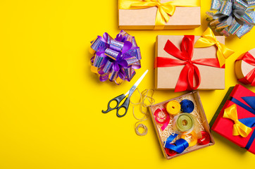 Ribbon bow gift boxes on yellow background, concept gift wrapping