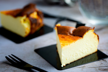 Close up of Basque Burnt Cheesecake on black dessert plate