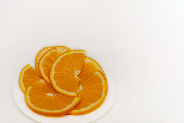 Slices of orange on a plate on a light background. Tangerines, Citrus, Fruits, Food, Vitamin C, Detox. Minimalism style.