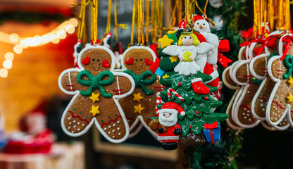 Ginger bread man and handmade Christmas toys on the street market, backdrop. Colorful New Year fair decor sale background.